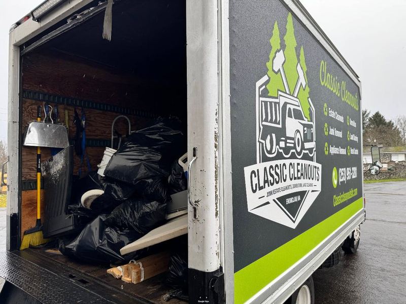 Box truck loaded on a junk removal job by Classic Cleanouts