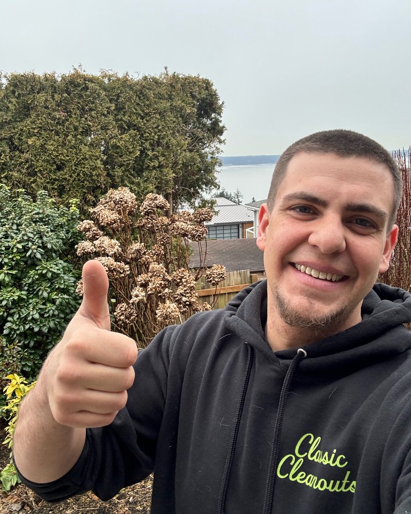 Roger, owner of Classic Cleanouts LLC, giving a thumbs up in a Classic Cleanouts hoodie